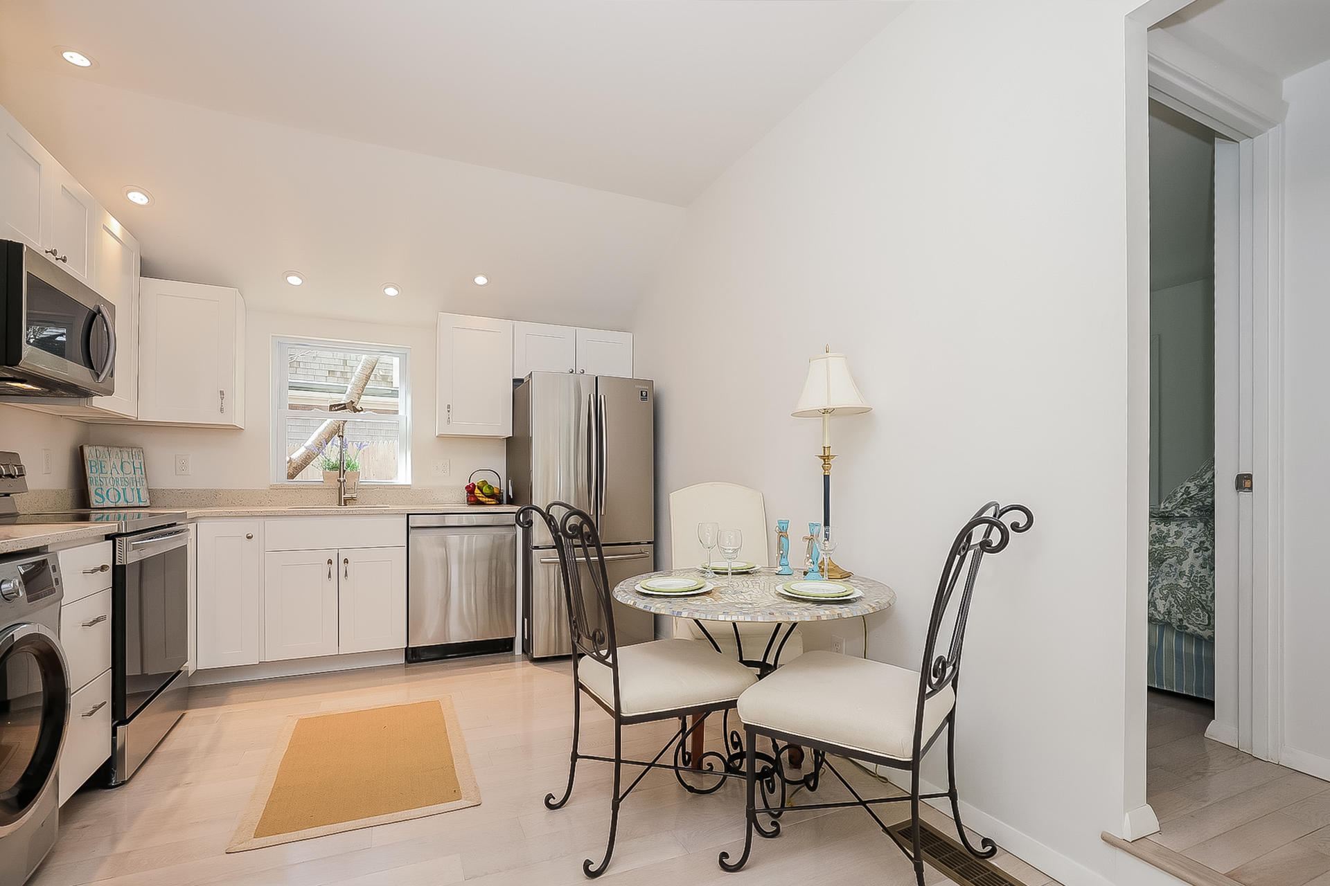 210 Chequessett Neck Road, Unit A Wellfleet, MA 02667 - Photo 14 of 33 a kitchen with a sink cabinets and appliances