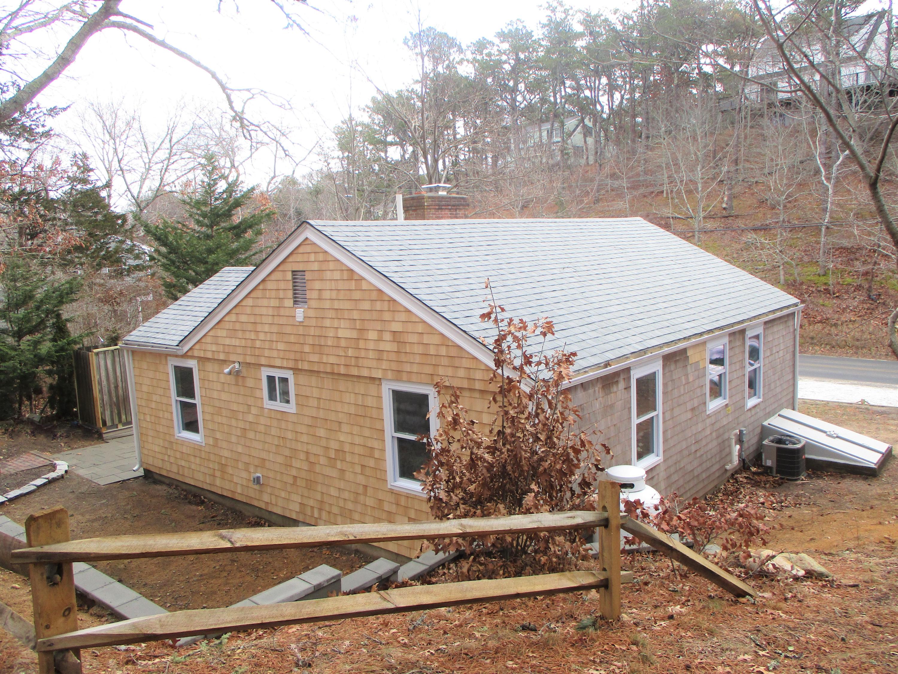 210 Chequessett Neck Road, Unit A Wellfleet, MA 02667 - Photo 25 of 33 a view of a house with a yard and large tree