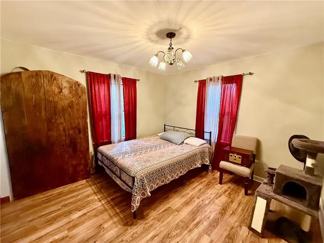 a bedroom with bed and a chandelier
