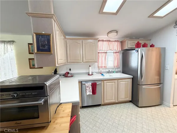a kitchen with stainless steel appliances granite countertop a stove and a refrigerator
