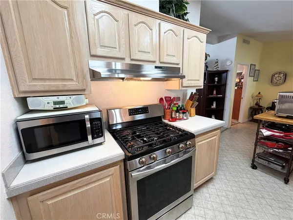 a kitchen with a sink stove top oven and cabinets