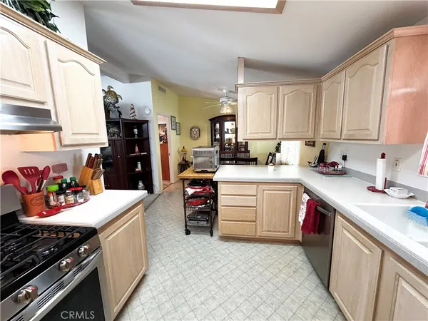 a kitchen with a refrigerator sink and cabinets