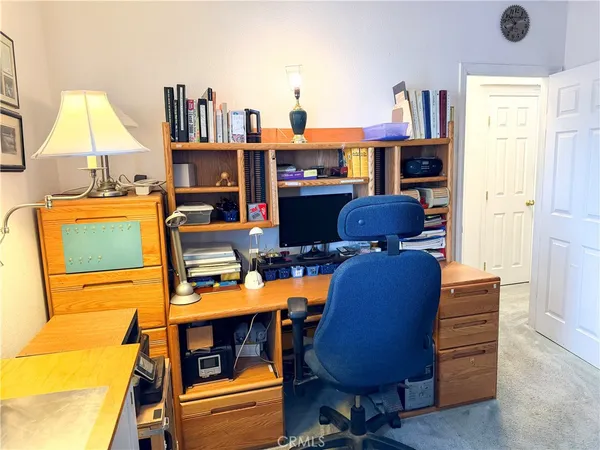 a view of a bedroom with furniture and window