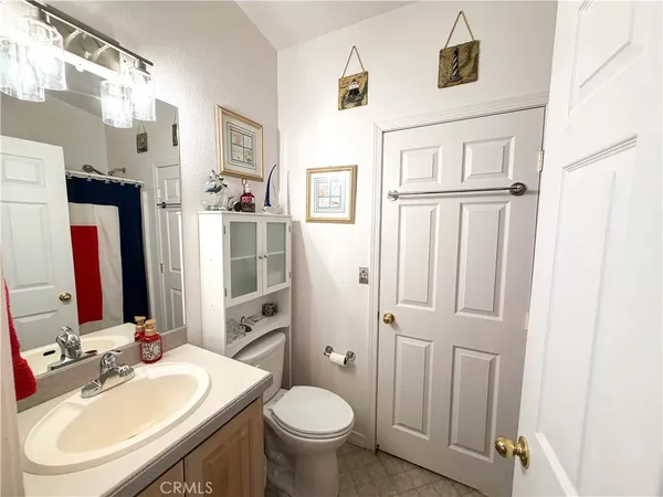 a bathroom with a sink vanity mirror and tub