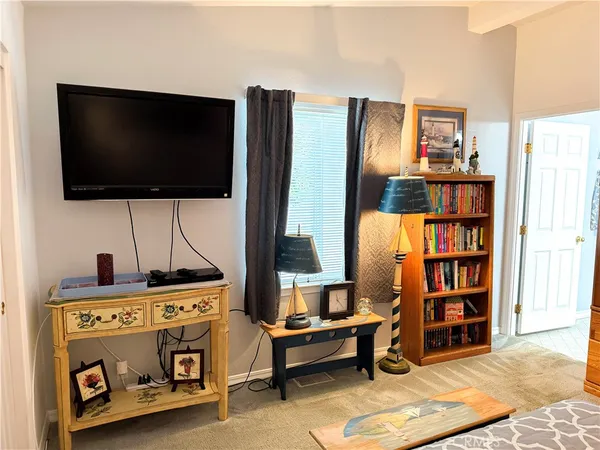 a view of a bedroom with workspace and shelf