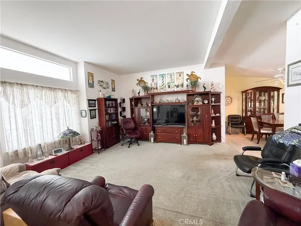 a bed room with furniture and a flat screen tv