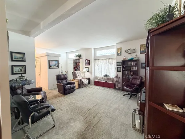 a bedroom with furniture and a book shelf