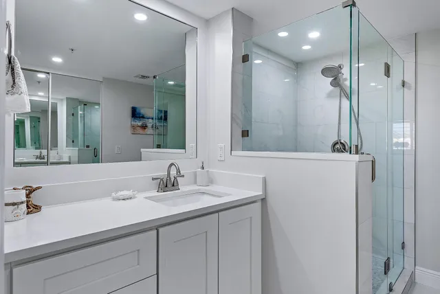 a bedroom with a bed and a lamp on the dresser