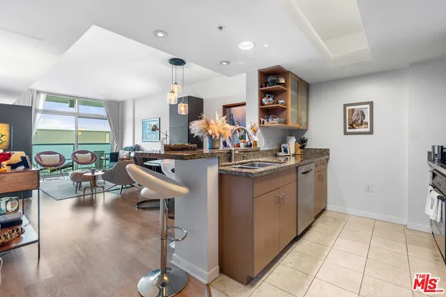 a very nice looking living room with dining room and lots of furniture