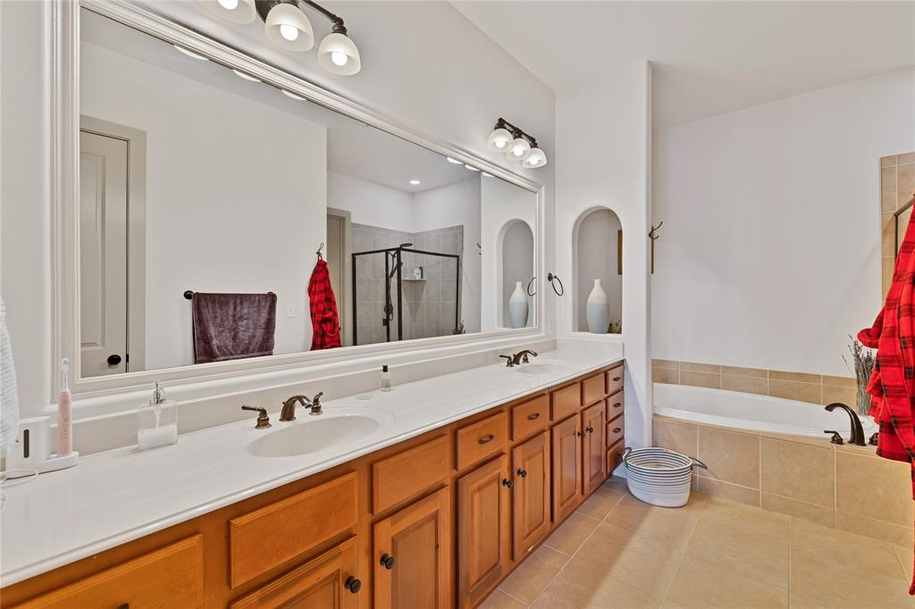 610 Via Ravello, Unit 207 Irving, TX 75039 - Photo 11 of 34 a bathroom with a double vanity sink double mirror and bathtub