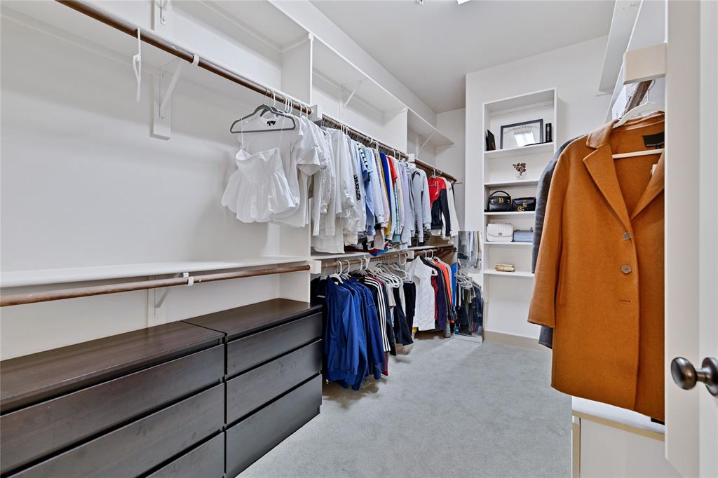 610 Via Ravello, Unit 207 Irving, TX 75039 - Photo 13 of 34 a view of walk in closet with clothes and shoes