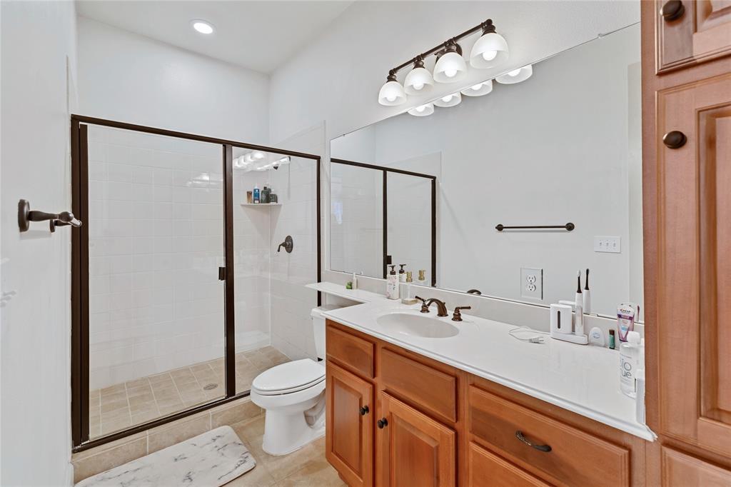 610 Via Ravello, Unit 207 Irving, TX 75039 - Photo 16 of 34 a bathroom with a double vanity sink toilet and shower