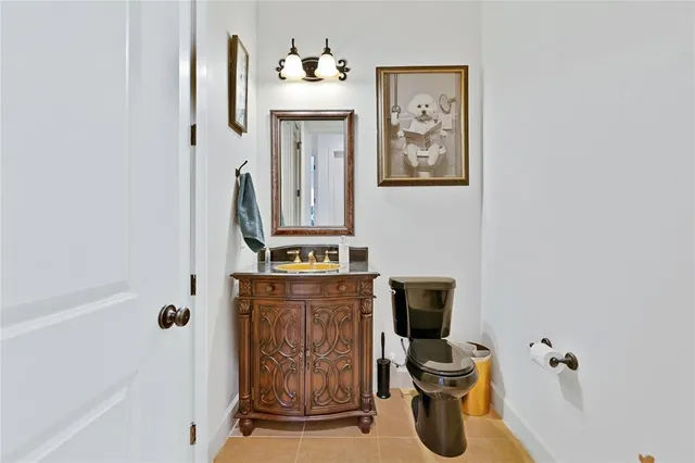 a bathroom with a toilet a sink and mirror
