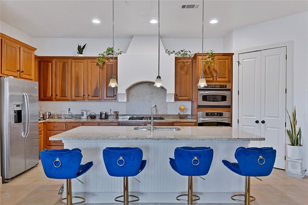 610 Via Ravello, Unit 207 Irving, TX 75039 - Photo 2 of 34 a kitchen with stainless steel appliances granite countertop a sink refrigerator and cabinets
