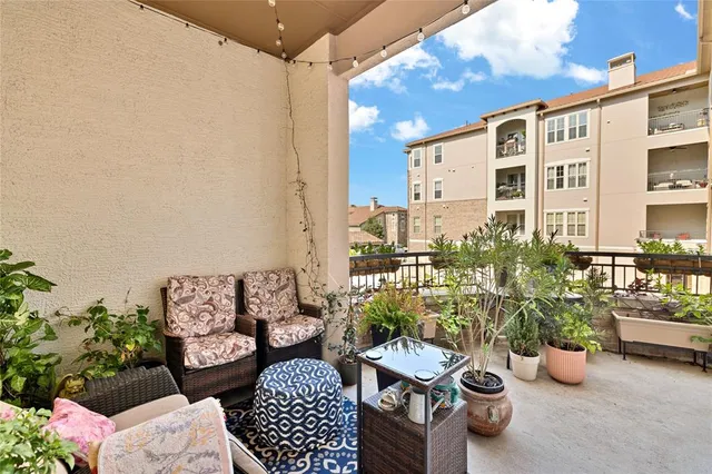 a view of a patio with couches and potted plants