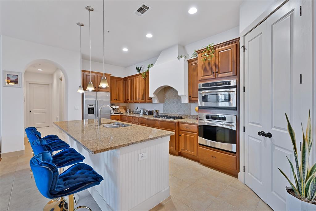 610 Via Ravello, Unit 207 Irving, TX 75039 - Photo 3 of 34 a kitchen with stainless steel appliances granite countertop a sink a stove and a refrigerator