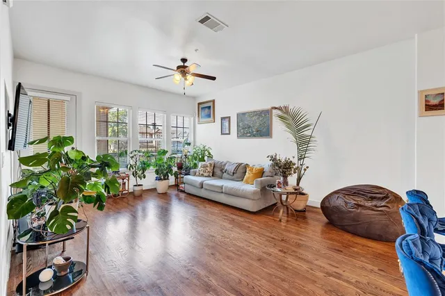 a living room with furniture and a potted plant