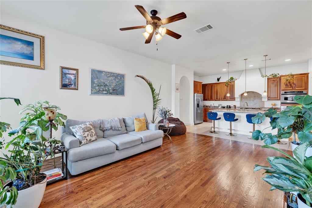 610 Via Ravello, Unit 207 Irving, TX 75039 - Photo 6 of 34 a living room with furniture kitchen view and a wooden floor