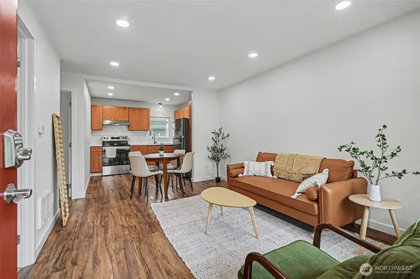 a living room with furniture and a wooden floor
