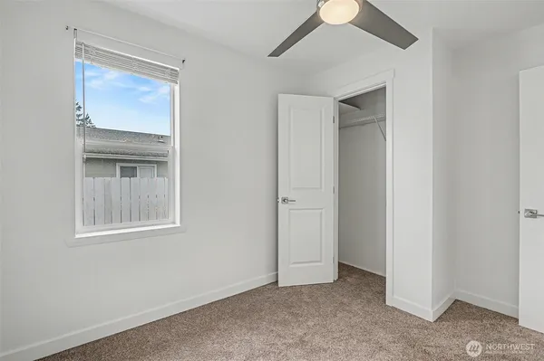 an empty room with windows and closet