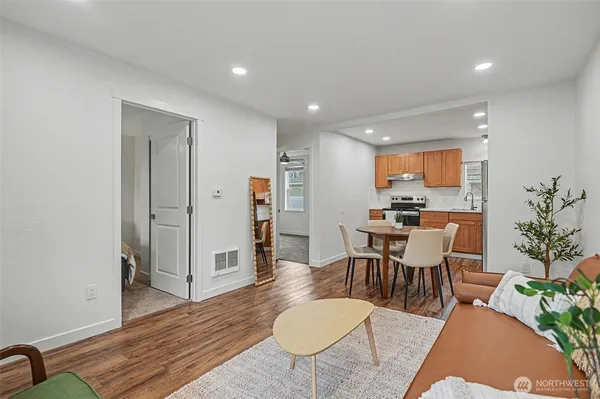 a living room with furniture a counter space and wooden floor
