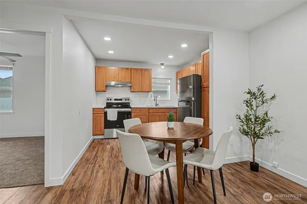 a kitchen with a table and chairs in it