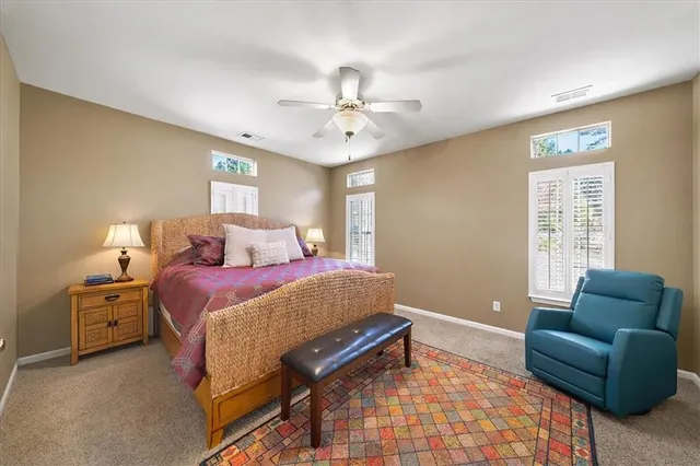 a bedroom with a bed couch and window