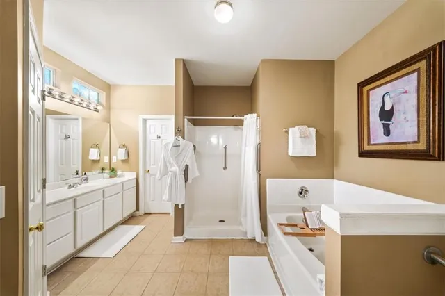 a bathroom with a tub sink and mirror