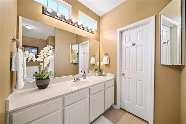 a bathroom with a double vanity sink and a mirror