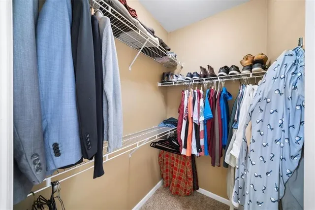 a view of walk in closet with clothes