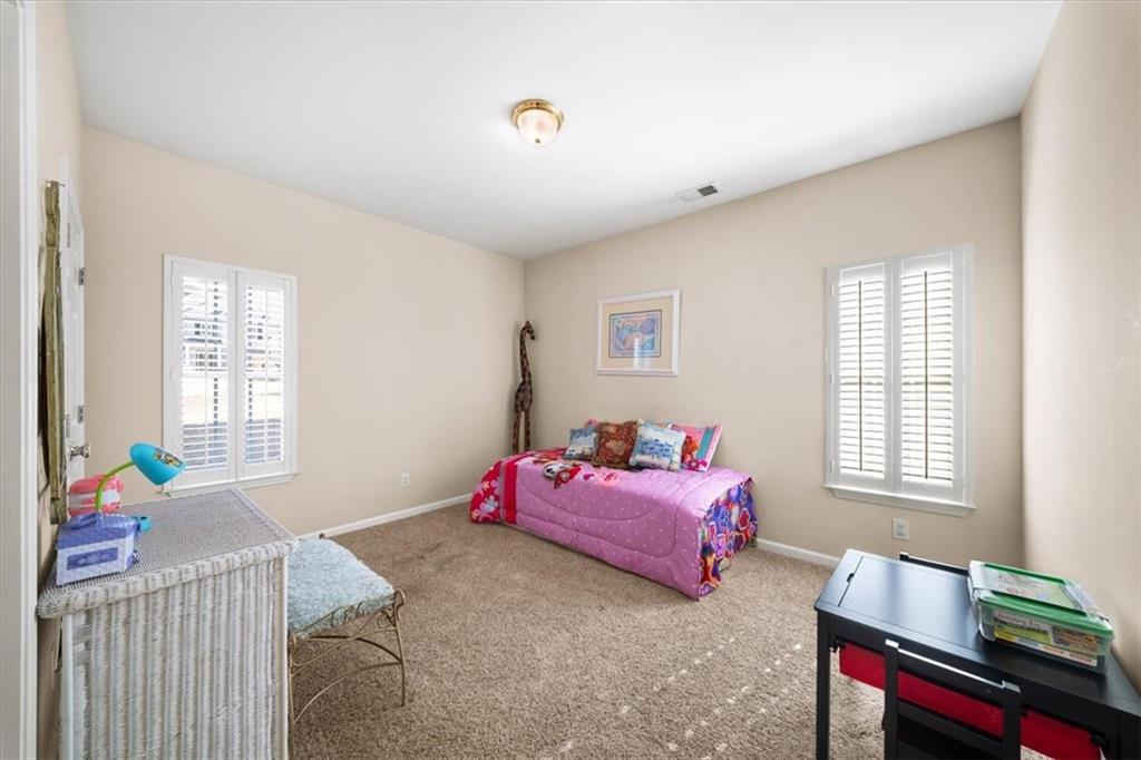 701 Redwood Pass Canton, GA 30114 - Photo 25 of 45 a bedroom with furniture and a window