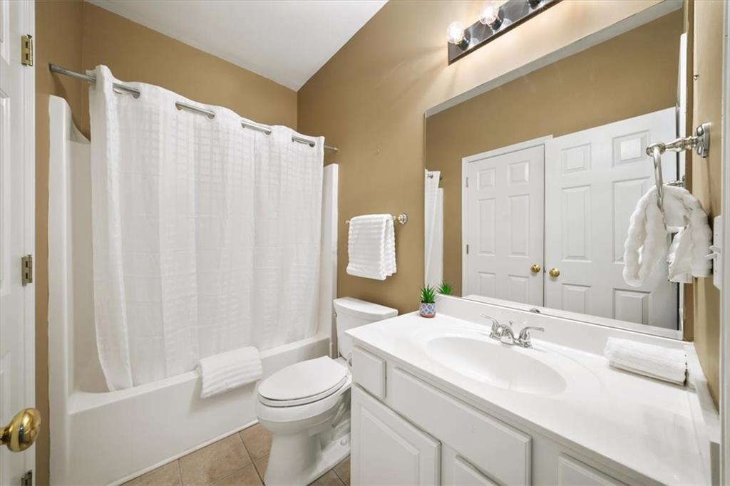 701 Redwood Pass Canton, GA 30114 - Photo 27 of 45 a bathroom with a sink a toilet and shower curtain