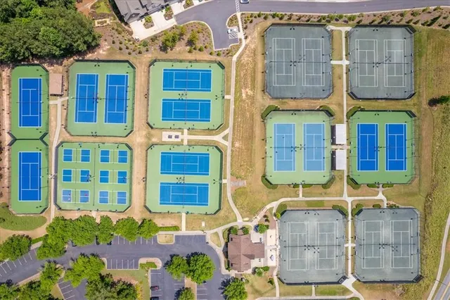 an aerial view of residential houses with outdoor space and trees