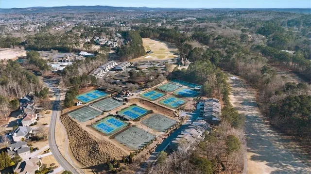 a view of a field with trees in the background