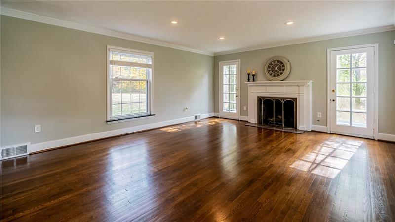 4578 Middle Road Allison Park, PA 15101 - Photo 3 of 25 VIRTUALLY STAGED PHOTO. The large family room featuring crown molding, hardwood floor and a classic wood burning fireplace. The fireplace is flanked by French doors leading to a large, awning covered patio.