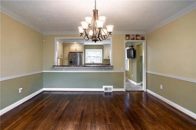 4578 Middle Road Allison Park, PA 15101 - Photo 6 of 25 VIRTUALLY STAGED PHOTO. The large dining room adorned with chair rail & crown molding overlooks into the kitchen.
