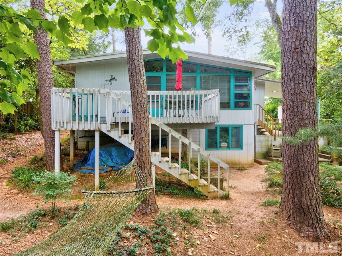 1324 Mayfair Road Raleigh, NC 27608 - Photo 3 of 8 a view of a house with a wooden deck and a trees