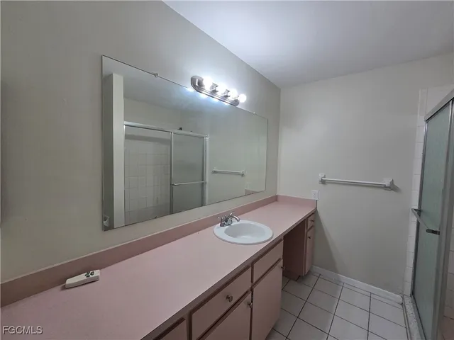a bathroom with a glass shower door