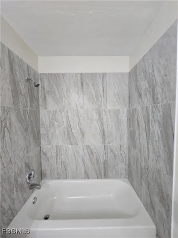 a bathroom with a sink a toilet a mirror and shower