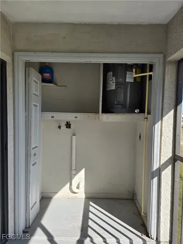 a view of a balcony with furniture and floor to ceiling window