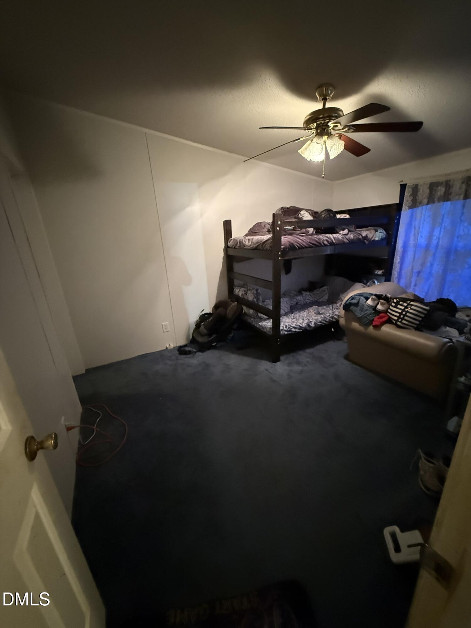 4749 Buckhorn Road Sanford, NC 27330 - Photo 15 of 18 a bed room with furniture and chandelier