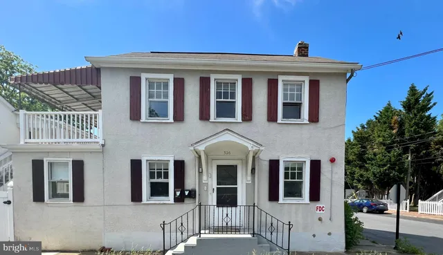 a front view of a house with a porch