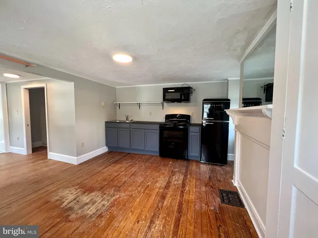 a kitchen with stainless steel appliances granite countertop a refrigerator a stove top oven a sink and dishwasher