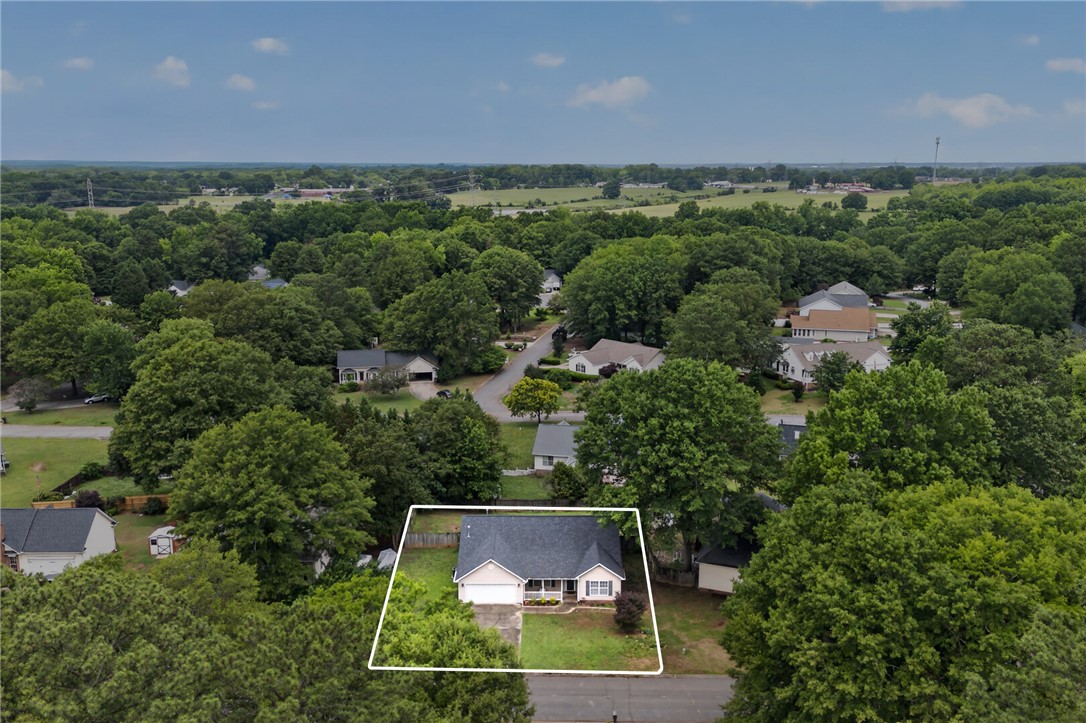 207 Hunters Lane Anderson, SC 29625 - Photo 31 of 46 An aerial perspective showcases a charming residence nestled amidst a vibrant, green landscape.