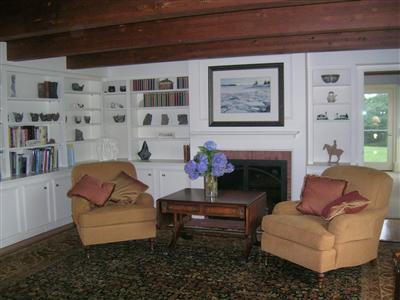 174 Eastward Road Chatham, MA 02633 - Photo 16 of 21 a living room with furniture and a fireplace