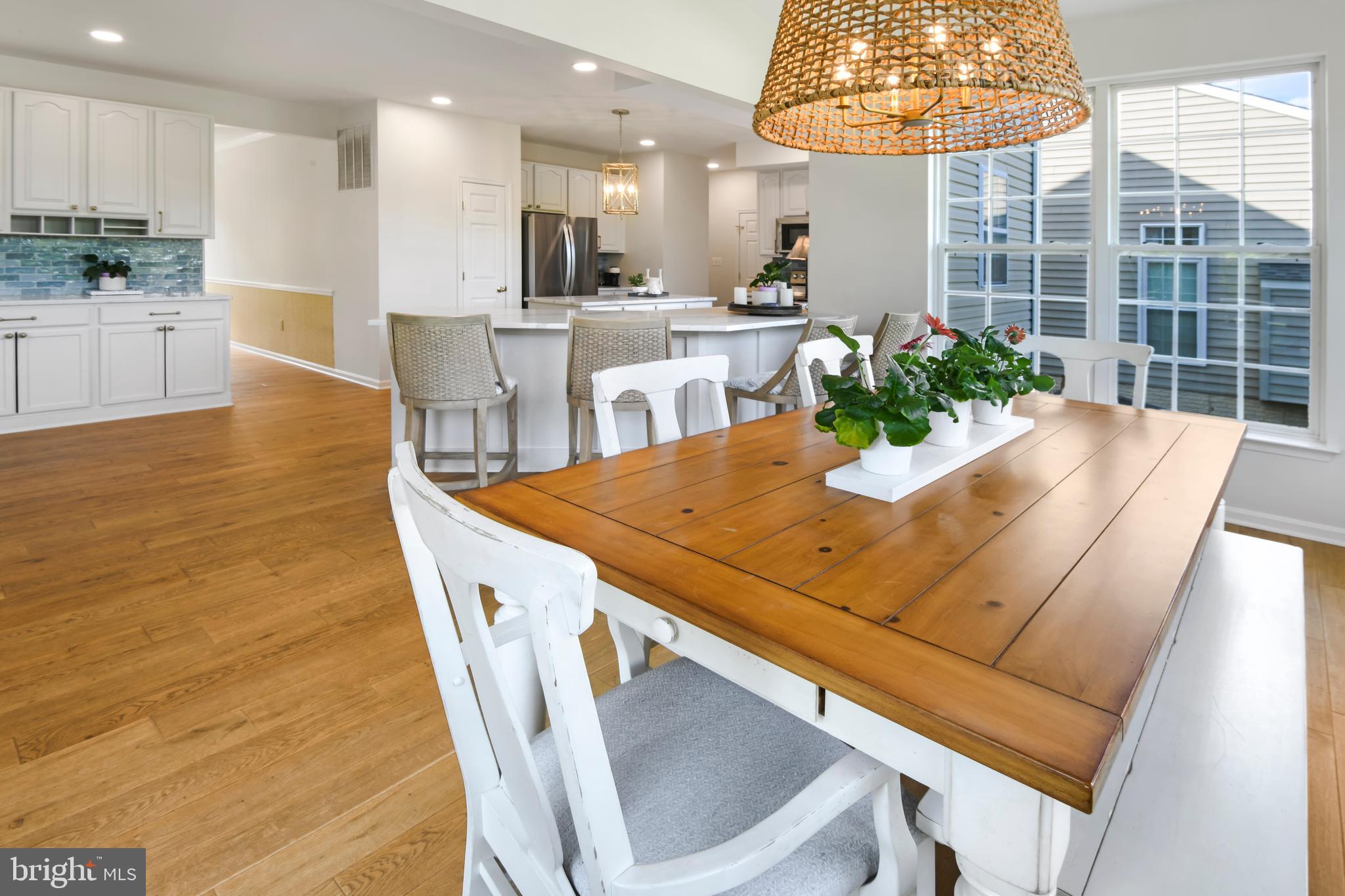 9105 Hendry Terrace Frederick, MD 21704 - Photo 11 of 51 a view of a dining room with furniture a chandelier and kitchen view