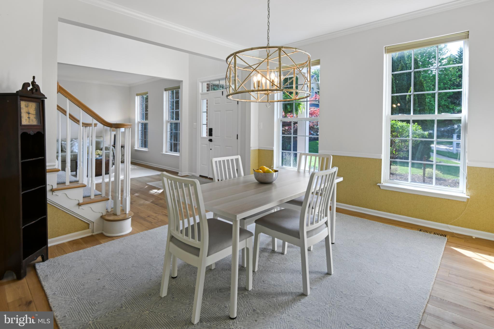 9105 Hendry Terrace Frederick, MD 21704 - Photo 14 of 51 a view of a dining room with furniture a chandelier and wooden floor