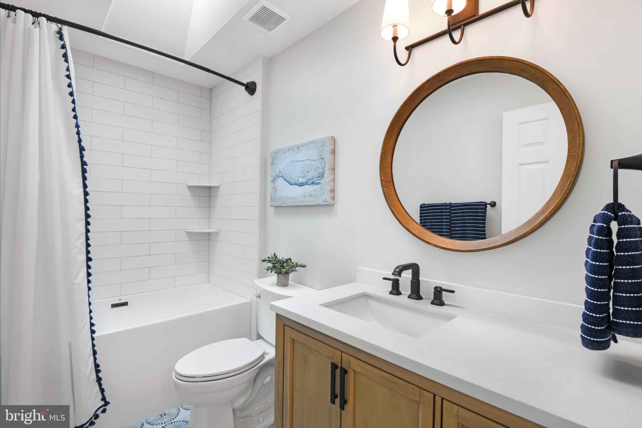 9105 Hendry Terrace Frederick, MD 21704 - Photo 23 of 51 a bathroom with a sink a toilet and a mirror