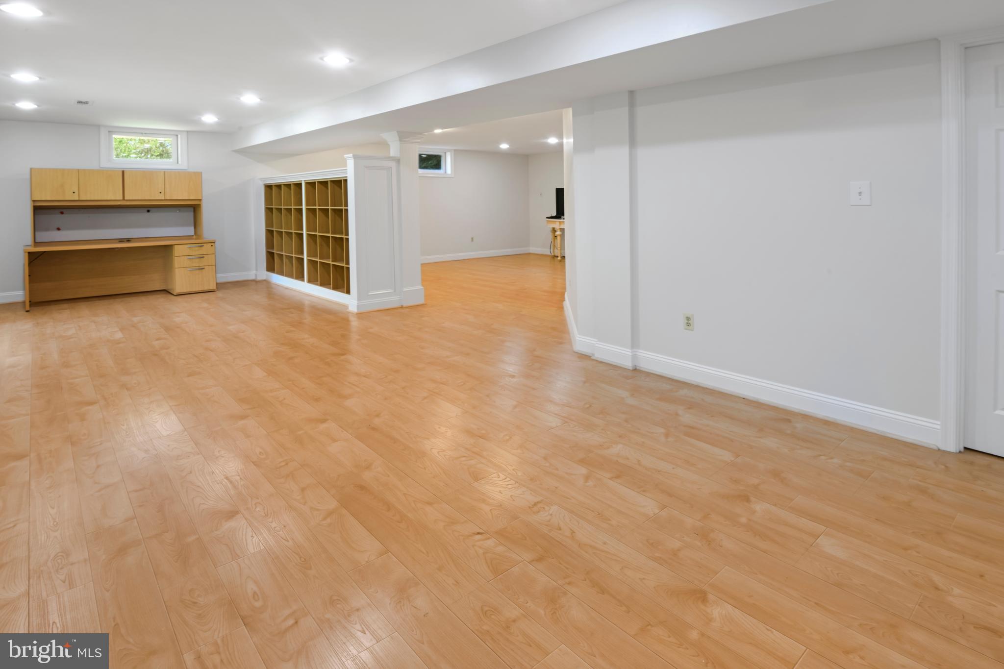 9105 Hendry Terrace Frederick, MD 21704 - Photo 30 of 51 an empty room with kitchen view and wooden floor