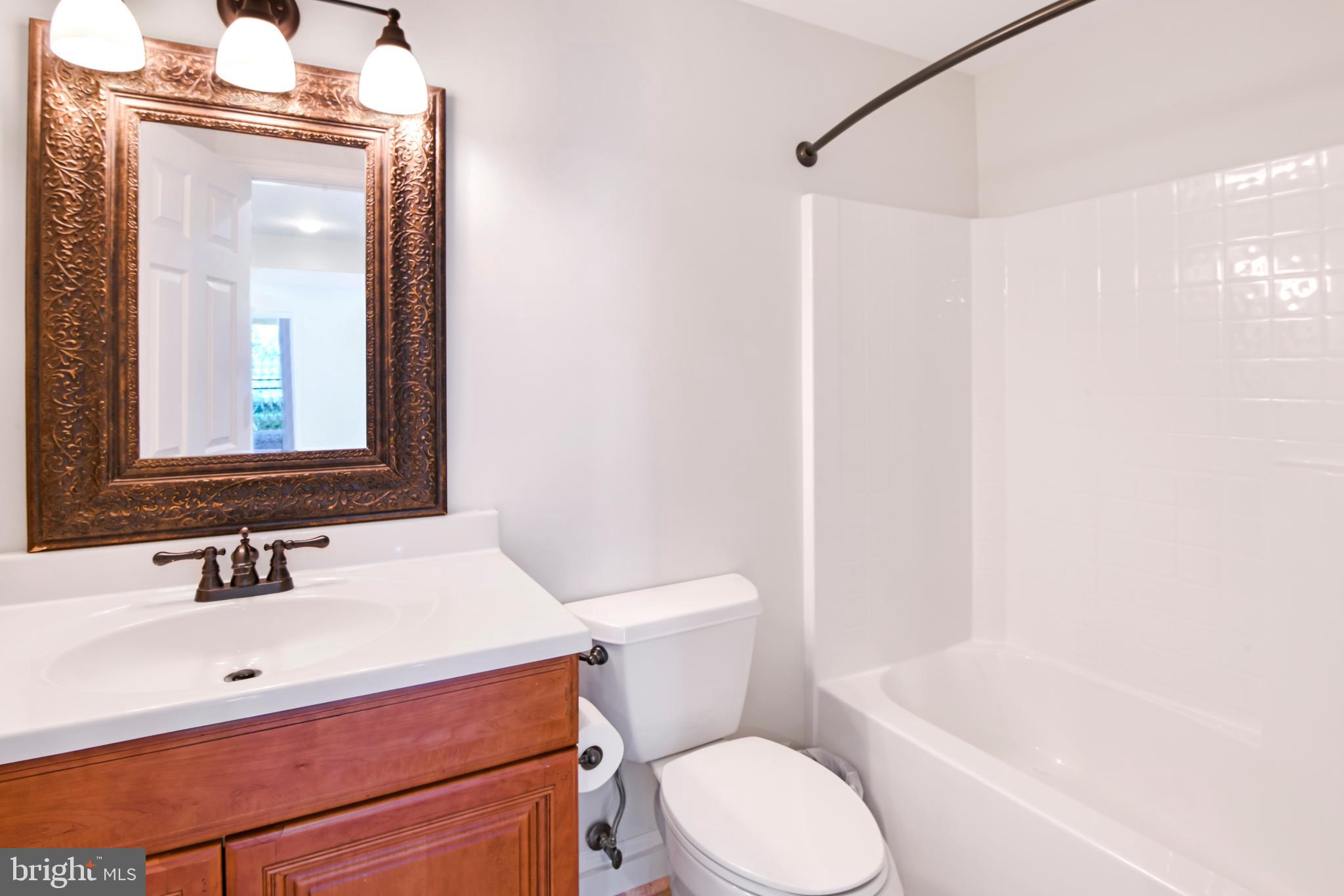 9105 Hendry Terrace Frederick, MD 21704 - Photo 35 of 51 a bathroom with a sink a toilet and shower